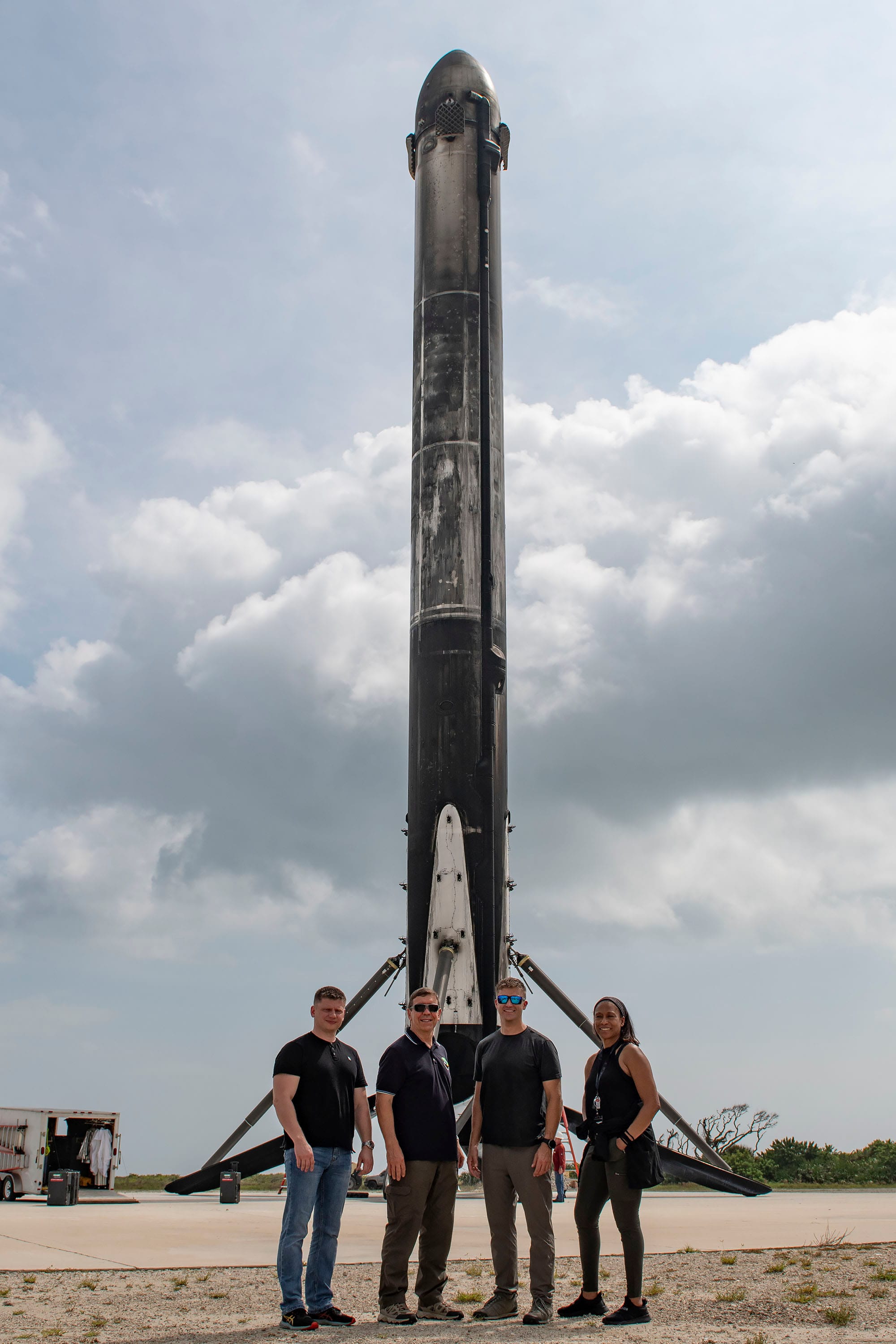 The Crew-8 astronauts in front of one of Falcon Heavy's boosters used for the Psyche mission, from left to right: Alexander Grebenkin, Michael Barratt, Matthew Dominick, and Jeanette Epps. ©SpaceX/NASA