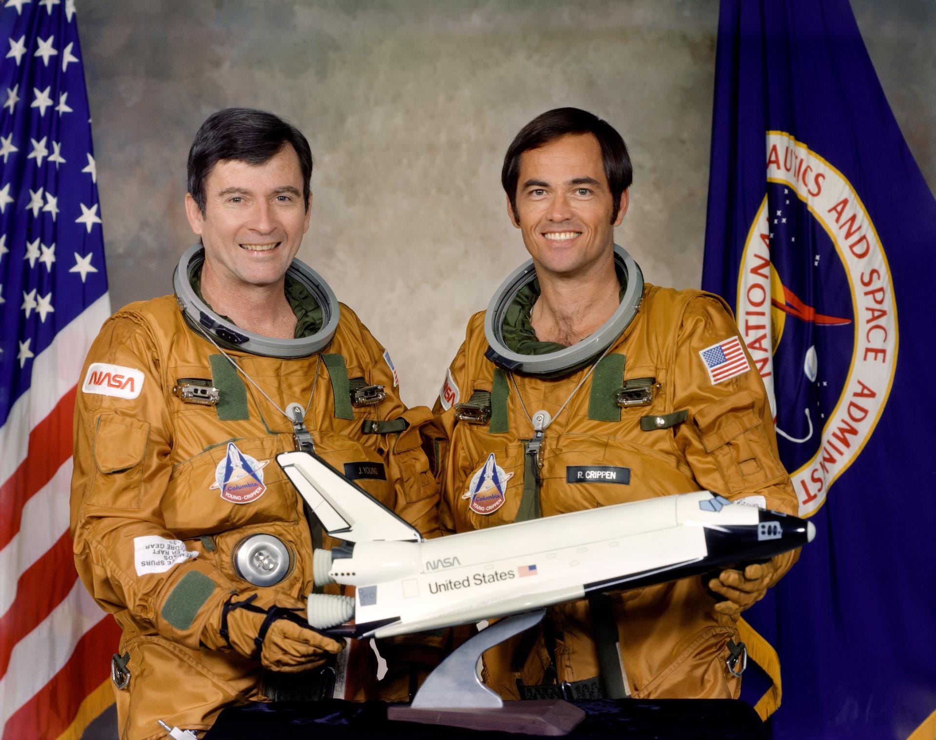 John Young (left) and Robert Crippen (right) with a model of the Space Shuttle in April 1979. ©NASA
