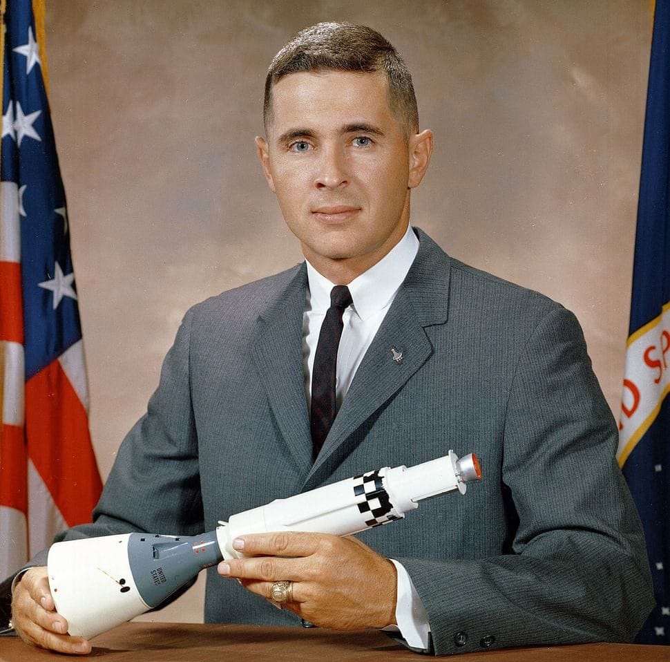 Bill Anders with a model of the Gemini spacecraft and its docking target vehicle in his 1964 NASA portrait. ©NASA