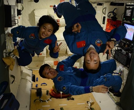 Liu Yang (left), Liu Wang (bottom), and Jing Haipeng (top) inside the Tiangong-1 space station.