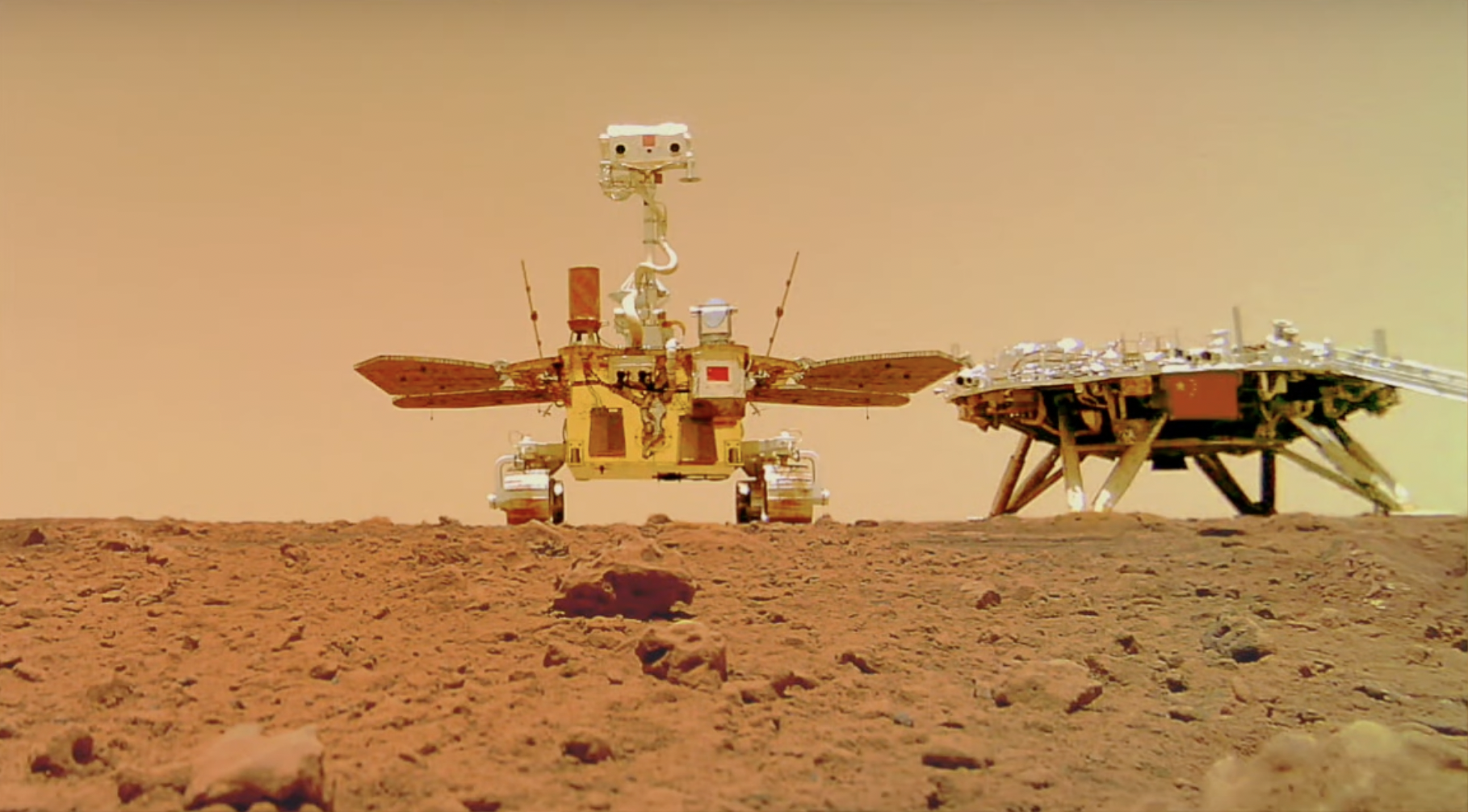 The Tianwen-1 lander (right) and Zhurong rover (left) photographed on the surface of Mars by a small deployable camera.