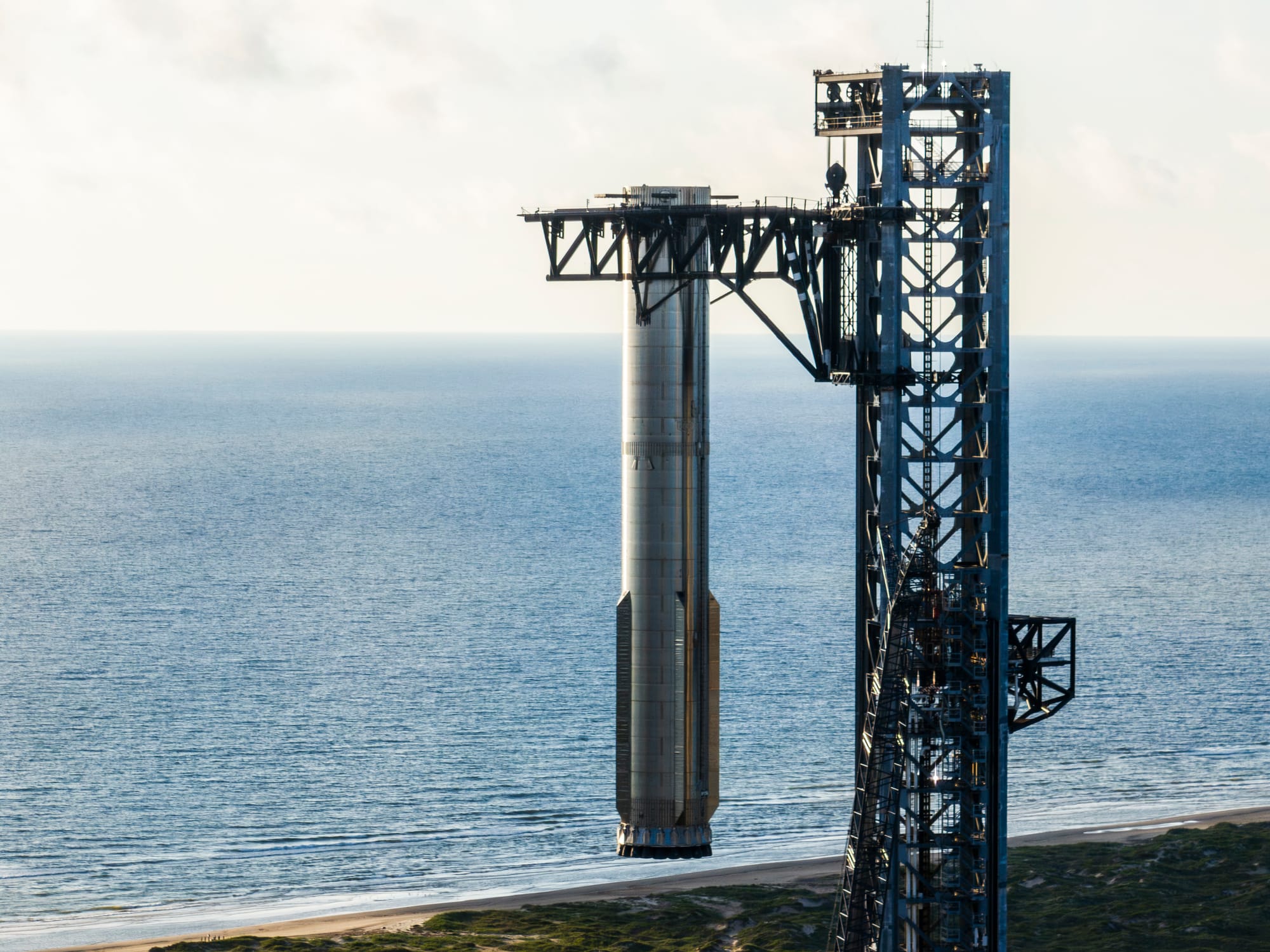 Booster 12 during a lift test with the launch towers 'chopsticks' in late September. ©SpaceX