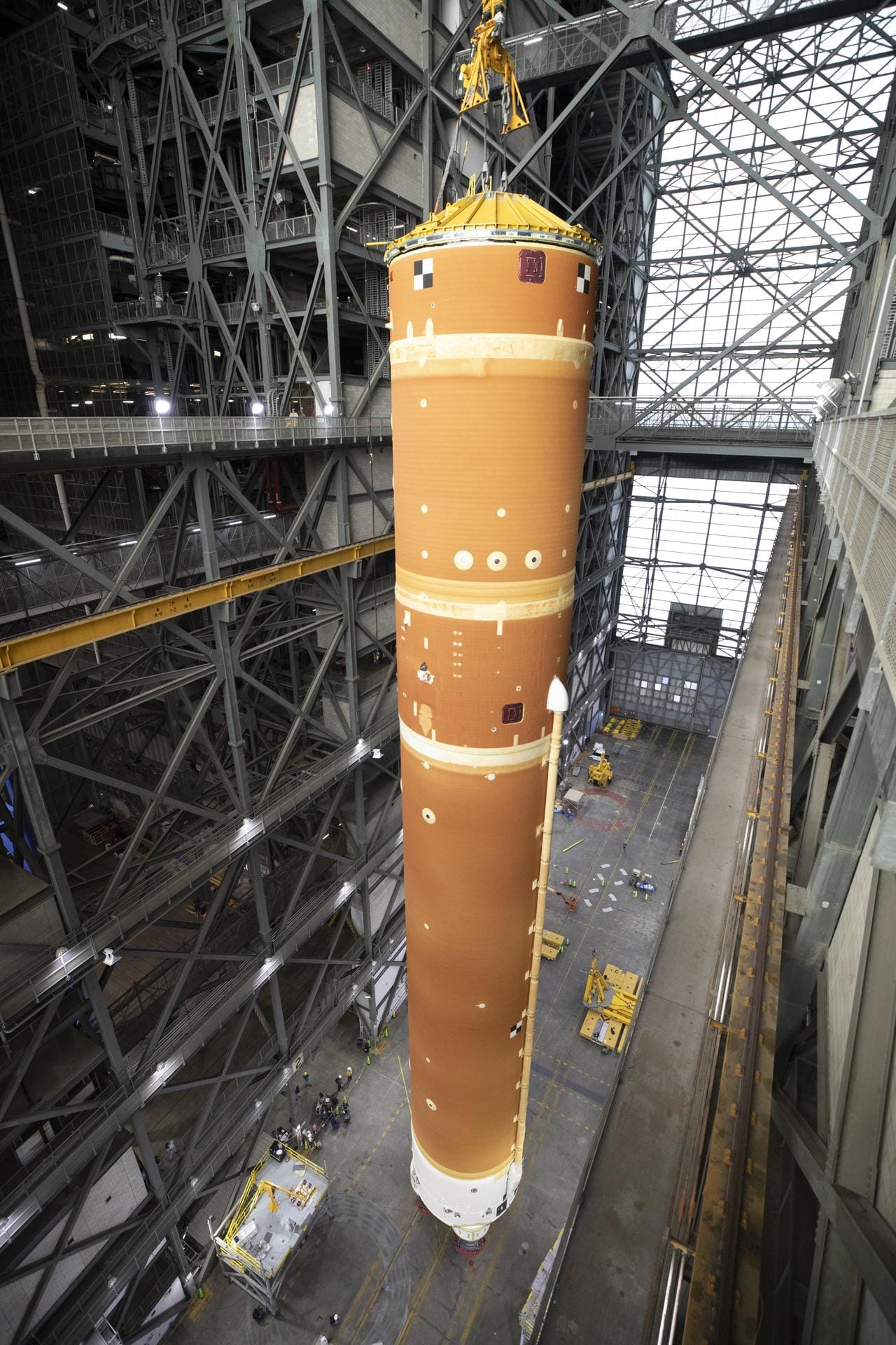 The SLS vehicles core stage for the Artemis II mission being lifted from VAB's transfer aisle. ©Kim Shiflett/NASA