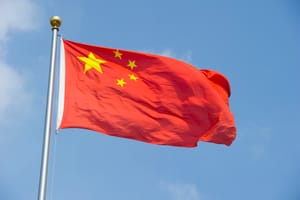The flag of the People's Republic of China flying in the wind.