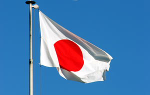 The Japanese flag flying in the wind.